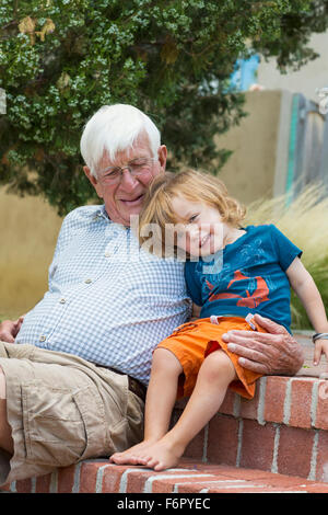 Caucasian grandfather and grandson hugging outdoors Stock Photo