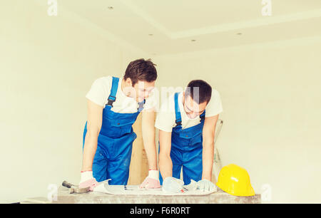 group of builders with blueprint Stock Photo