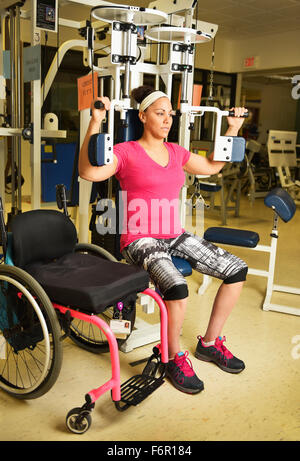 Paraplegic woman working out in physical therapy Stock Photo