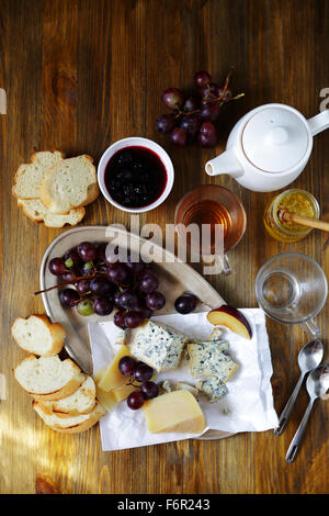 cheese with grapes on breakfast table, top view Stock Photo