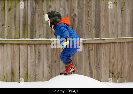 Caucasian boy playing in snow Stock Photo