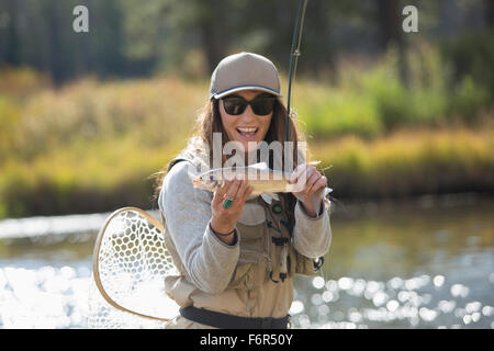 Caucasian woman displaying fishing catch