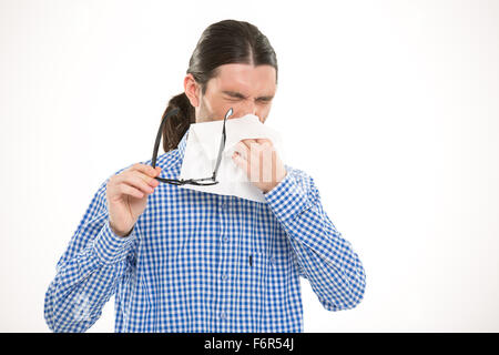 Young handsome man sneezing and using handkerchief Stock Photo