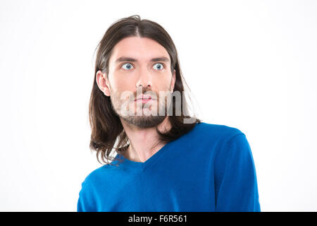 Young handsome man with long hair in blue sweetshirt looking surprised Stock Photo