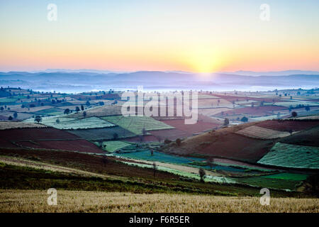 Sunrise over farmland in rural landscape Stock Photo