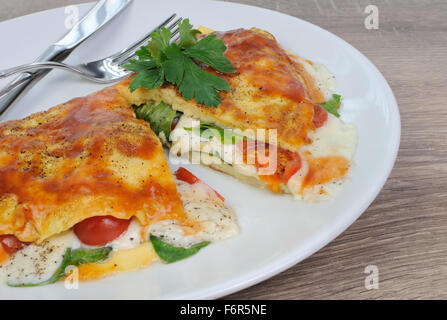 Omelet stuffed with spinach, tomato and  mozzarella Stock Photo