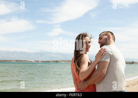 Young couple flirting on beach Stock Photo