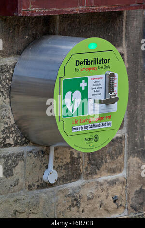 Defibrillator outside on a public wall in the village of Stock Photo