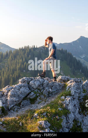 Young man overlooking mountain landscape Stock Photo