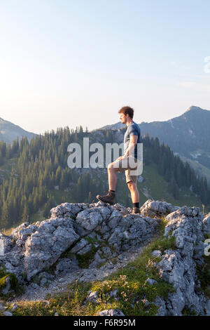 Young man overlooking mountain landscape Stock Photo
