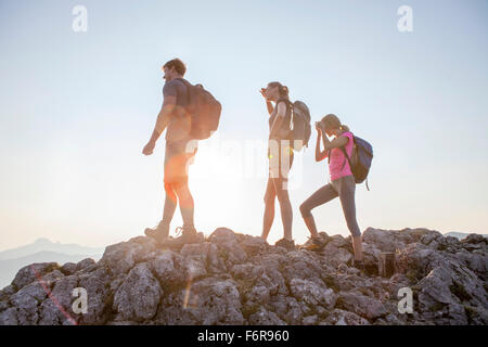 Group of friends overlooking mountain landscape Stock Photo