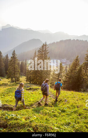 Group of friends hiking in mountain landscape Stock Photo