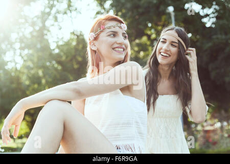 Young women in hippie style fashion laughing Stock Photo