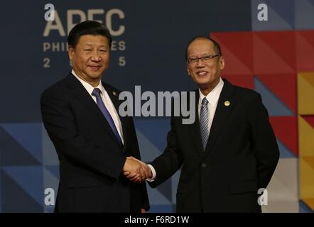 Manila, Philippines. 19th November, 2015. Philippine President Benigno Aquino III greets Chinese President Xi Jinping during the APEC Leaders Summit at the Philippine International Convention Center November 19, 2015 in Pasay City, Manila, Philippines. Stock Photo