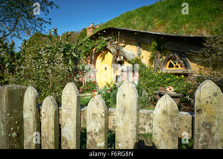 Fence detail with hobbit home in background. Hobbiton New Zealand
