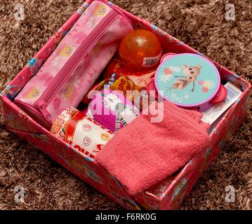 A charity appeal shoe box with presents for a girl Stock Photo
