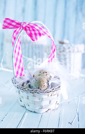 quail eggs in basket and on a table Stock Photo