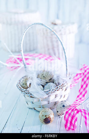 quail eggs in basket and on a table Stock Photo