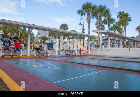 Senior citizens playing competitive shuffleboard game in Flager Ave in New Smyrna Beach Florida Stock Photo