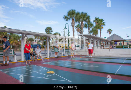 Senior citizens playing competitive shuffleboard game in Flager Ave in New Smyrna Beach Florida Stock Photo
