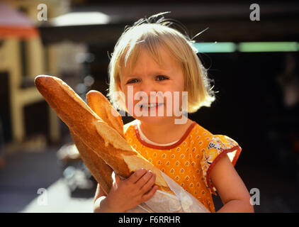 Child holding baguettes. France. Stock Photo