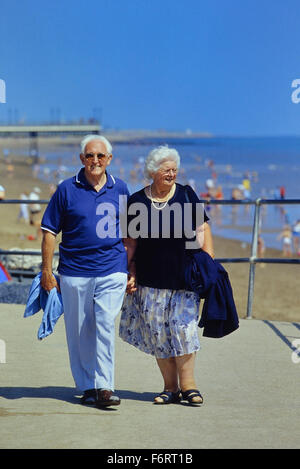 An elderly couple on Skegness promenade. Lincolnshire. England. UK Stock Photo