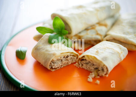 thin pancakes stuffed with meat on the table Stock Photo