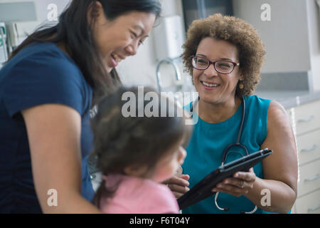 Doctor using digital tablet with patients Stock Photo