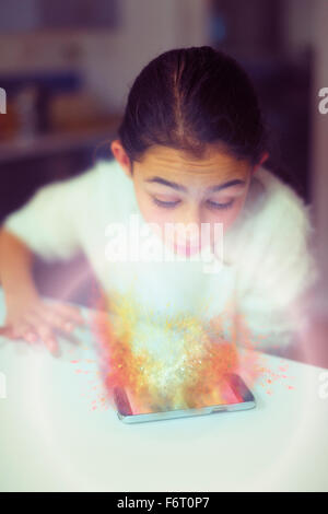 Mixed race girl examining hologram projection Stock Photo