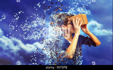 Dissolving mixed race boy peering in box Stock Photo