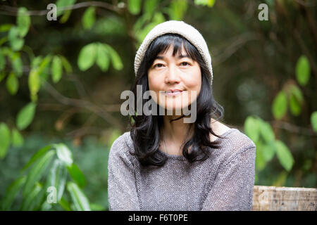 Japanese woman sitting in garden