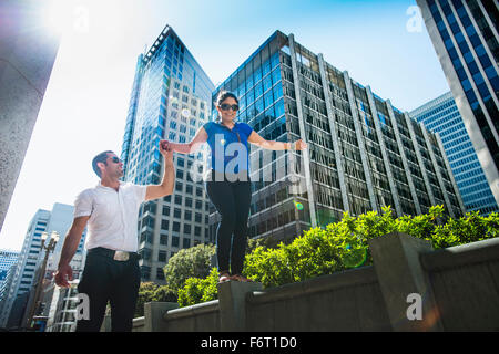 Hispanic couple walking in city Stock Photo