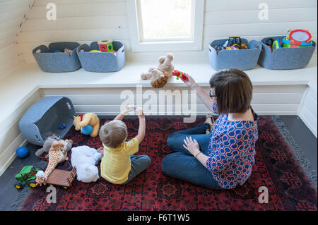 Mother and son playing on floor Stock Photo
