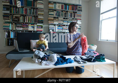 Mother and son folding laundry Stock Photo
