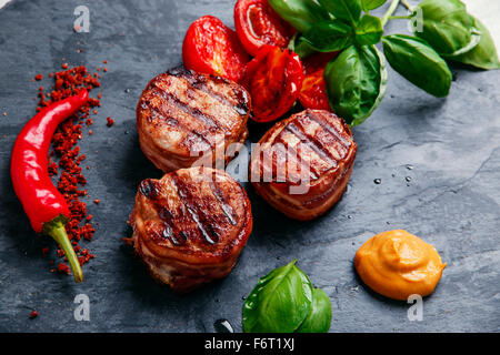 Grilled meat fillet steak wrapped in bacon medallions Stock Photo