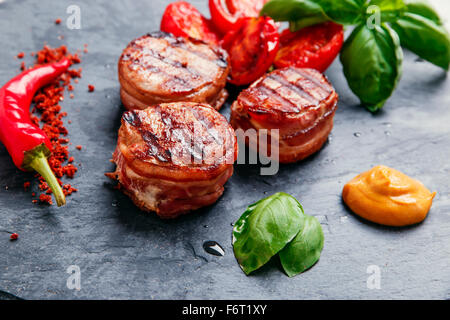 Grilled meat fillet steak wrapped in bacon medallions Stock Photo