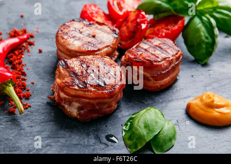 Grilled meat fillet steak wrapped in bacon medallions Stock Photo