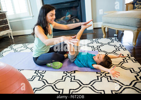 Mother and son playing on floor Stock Photo