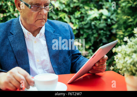 Hispanic businessman using digital tablet Stock Photo