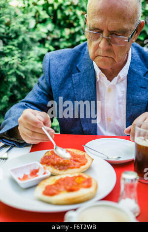 Hispanic businessman eating breakfast outdoors Stock Photo