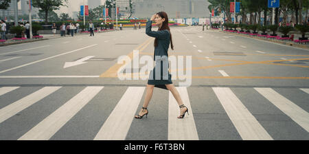 Chinese businesswoman in pedestrian crossing Stock Photo