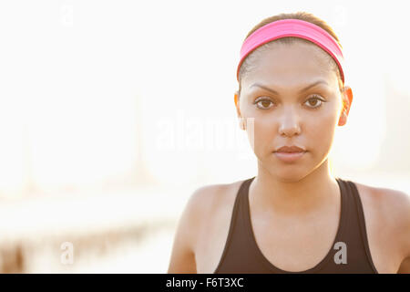 Serious Hispanic woman wearing headband Stock Photo
