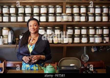 Black woman drinking tea in tea shop Stock Photo