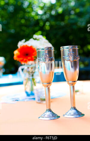 Bride and groom his and hers cups at a wedding reception ready for the big toast. Stock Photo