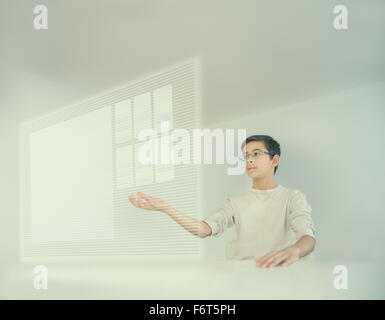 Mixed race boy using holographic screen Stock Photo