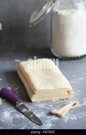 Homemade puff pastry dough on a floured surface Stock Photo