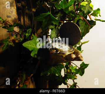 statue,face,sculpture,ivy leaves,time,watch,buddism,eaastern religion,religuos icon, Stock Photo