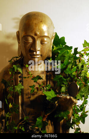 statue,face,sculpture,ivy leaves,time,watch,buddism,eaastern religion,religuos icon, Stock Photo