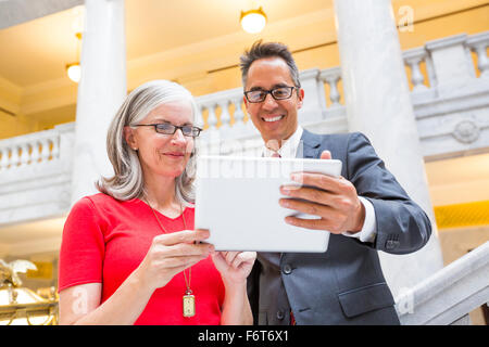 Business people using digital tablet in courthouse Stock Photo