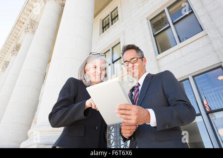 Business people talking outside courthouse Stock Photo